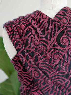 Close up of a black wrap with pink art deco pattern on a mannequin