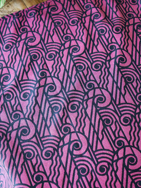 Reverse of a black wrap with pink art deco pattern