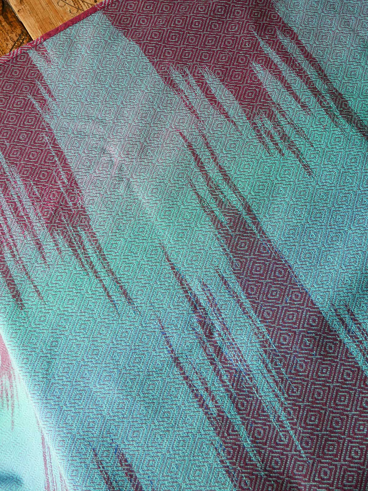 Reverse of a fabric with blue and red tones.
