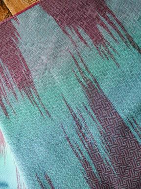 Reverse of a fabric with blue and red tones.