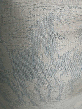 Textured fabric with a subtle horse pattern in neutral tones