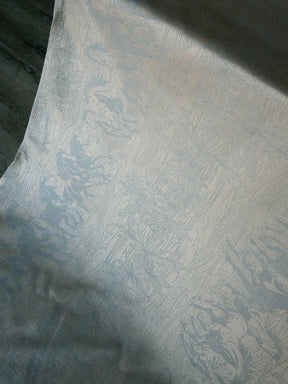 Textured neutral fabric with a subtle horse pattern on a dark background