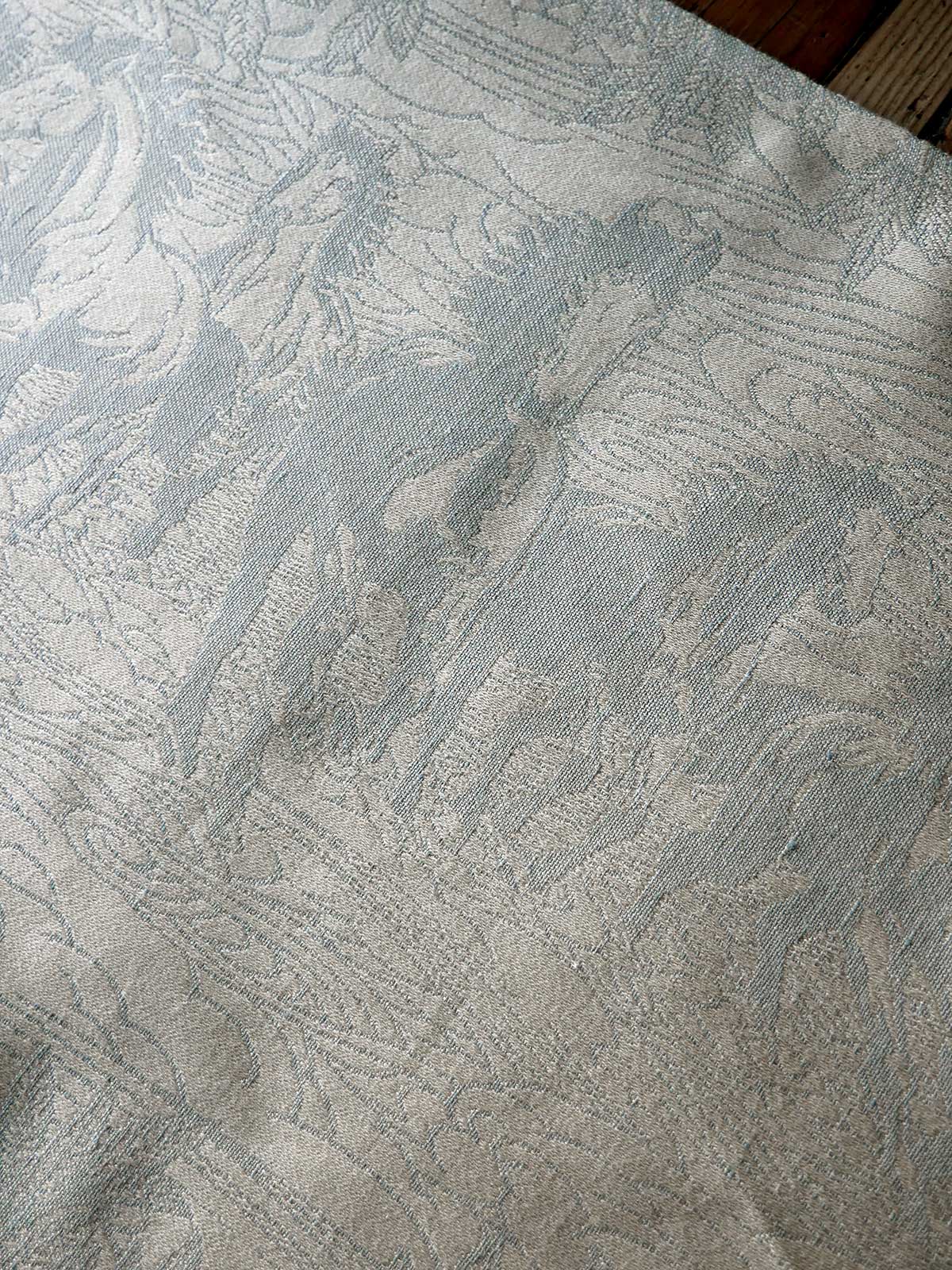 Textured neutral fabric with a subtle horse pattern