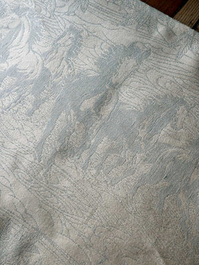 Textured neutral fabric with a subtle horse pattern