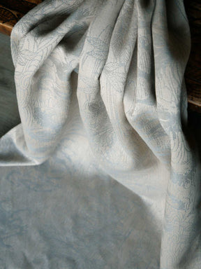 Textured fabric with a subtle pattern draped over a surface