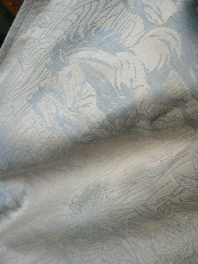 Textured fabric with a subtle pattern in neutral shades.