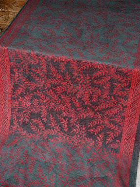 Textile with red and black pattern on a wooden floor