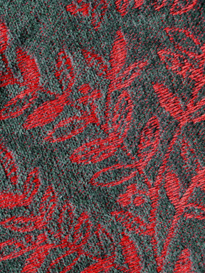 Textured fabric with red floral pattern on a dark background
