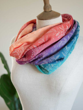 Stack of colorful scarves on a mannequin with a white background