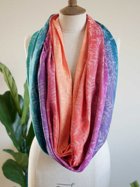 Colorful scarf on a mannequin with a plant in the background