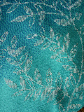 Close-up of teal fabric with leaf pattern