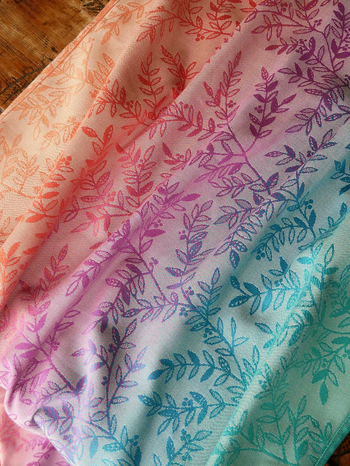 Gradient fabric with leaf pattern transitioning from orange to green.