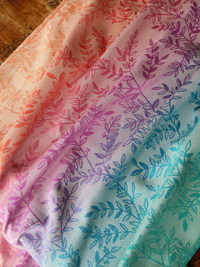 Gradient fabric with leaf pattern transitioning from orange to green.