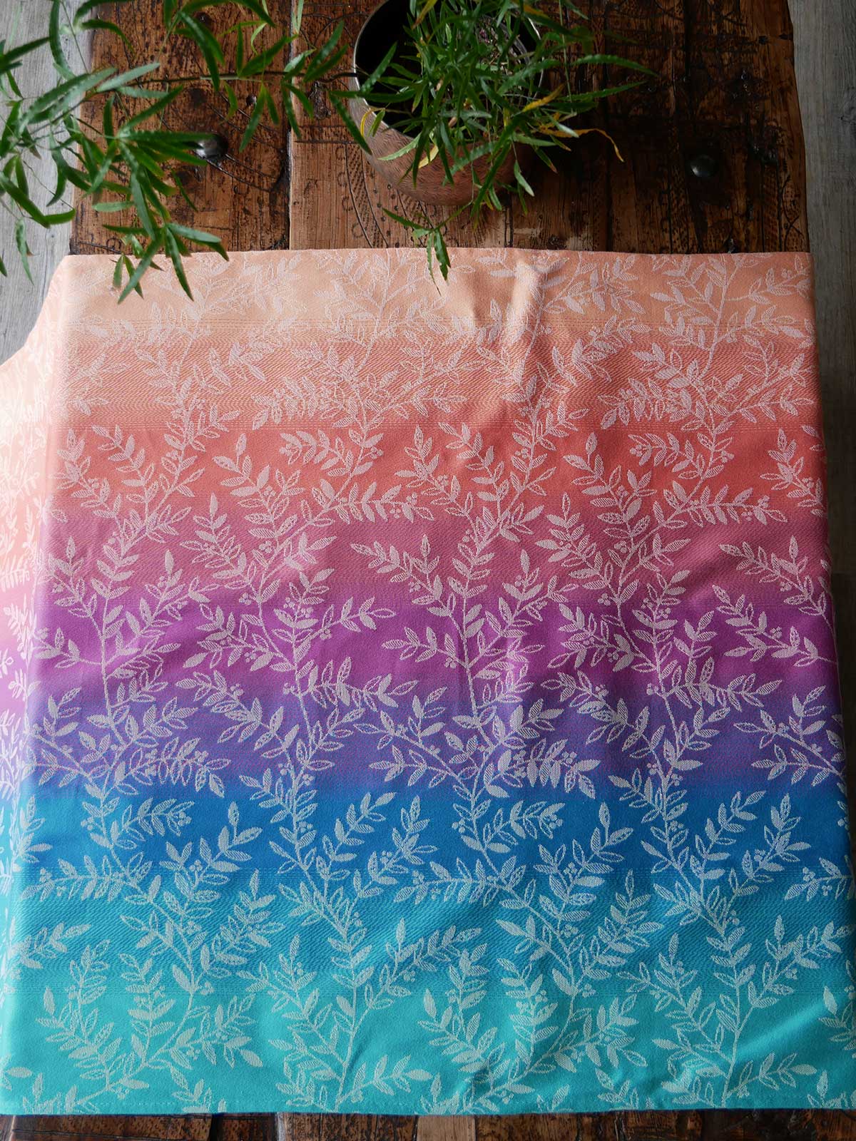 Gradient fabric with leaf pattern on a wooden surface