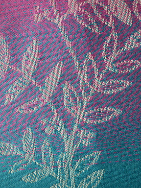 Close-up of a textured fabric with a geometric pattern in pink and blue.
