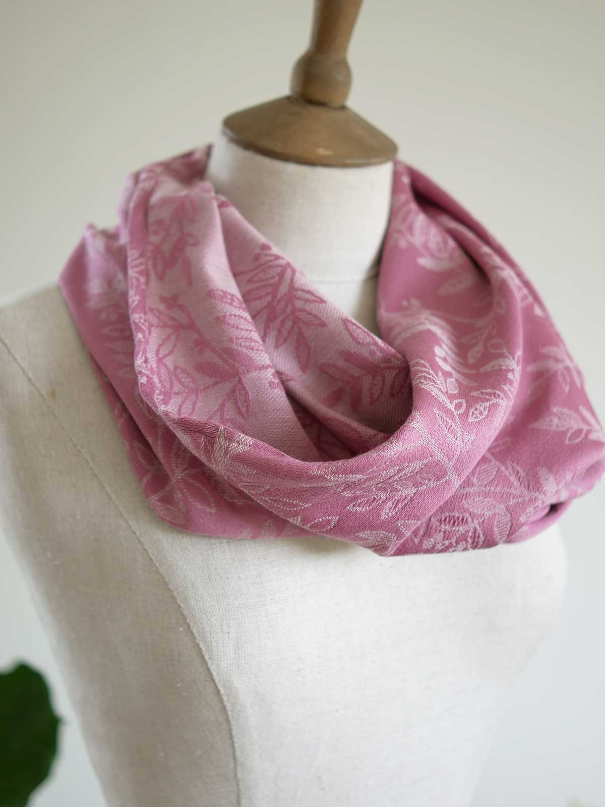 Pink cowl with a willow leaf pattern on a mannequin