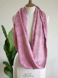 Pink infinity loop with a willow leaf pattern on a mannequin