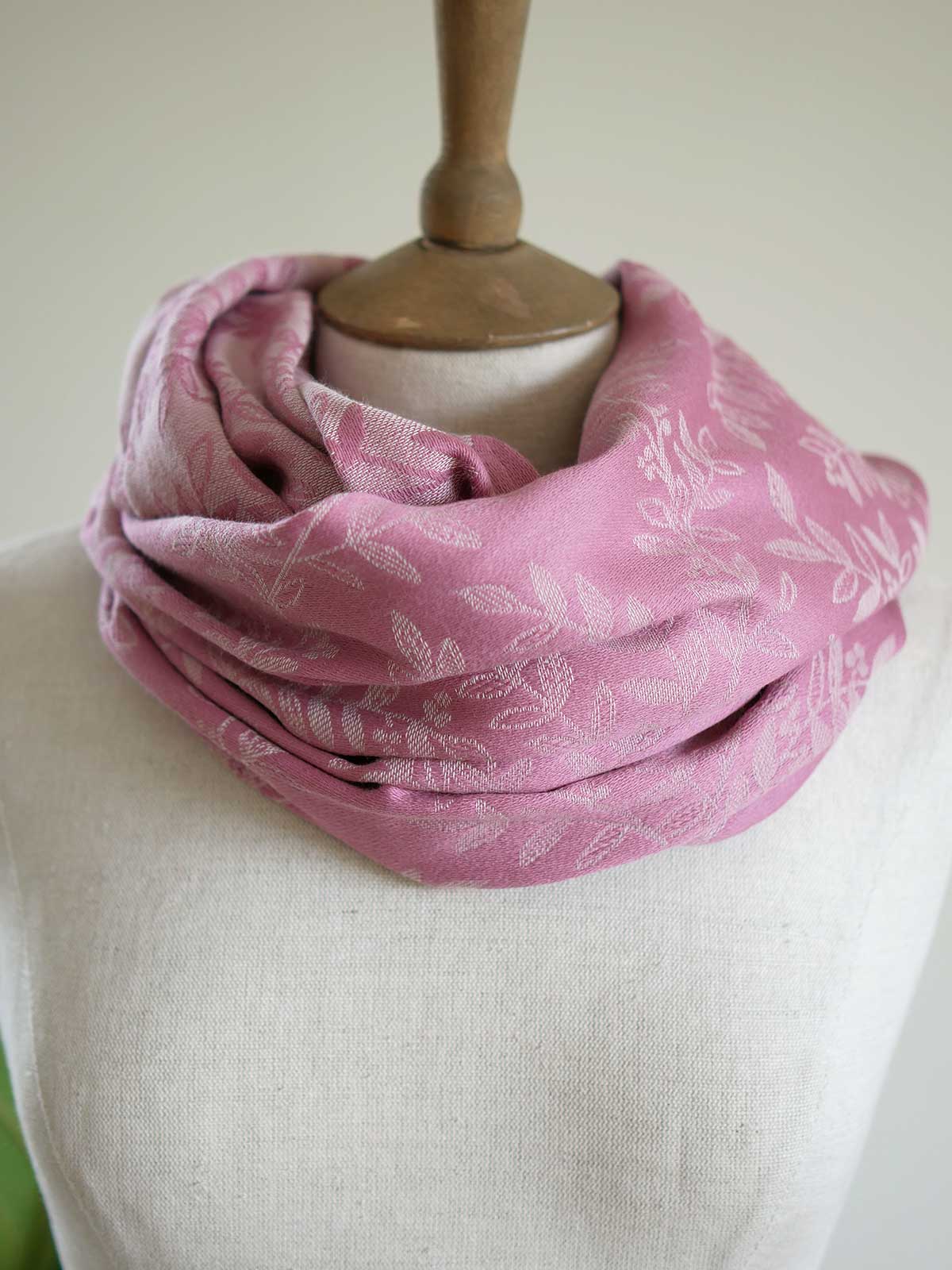 Pink infinity loop with a willow leaf pattern on a mannequin
