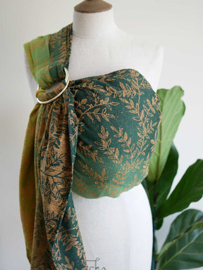 Green ring sling with gold leaf pattern on a mannequin