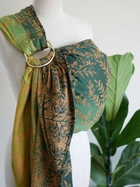 Side view of green ring sling with gold leaf pattern on a mannequin