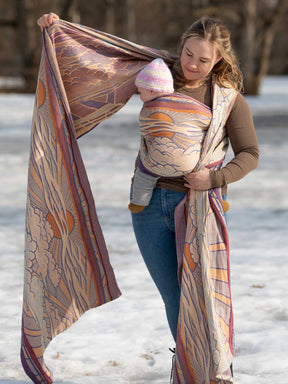 Woman holding a large patterned sling outdoors in a snowy setting