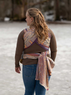 Woman wearing a patterned wrap over her shoulder in a snowy landscape