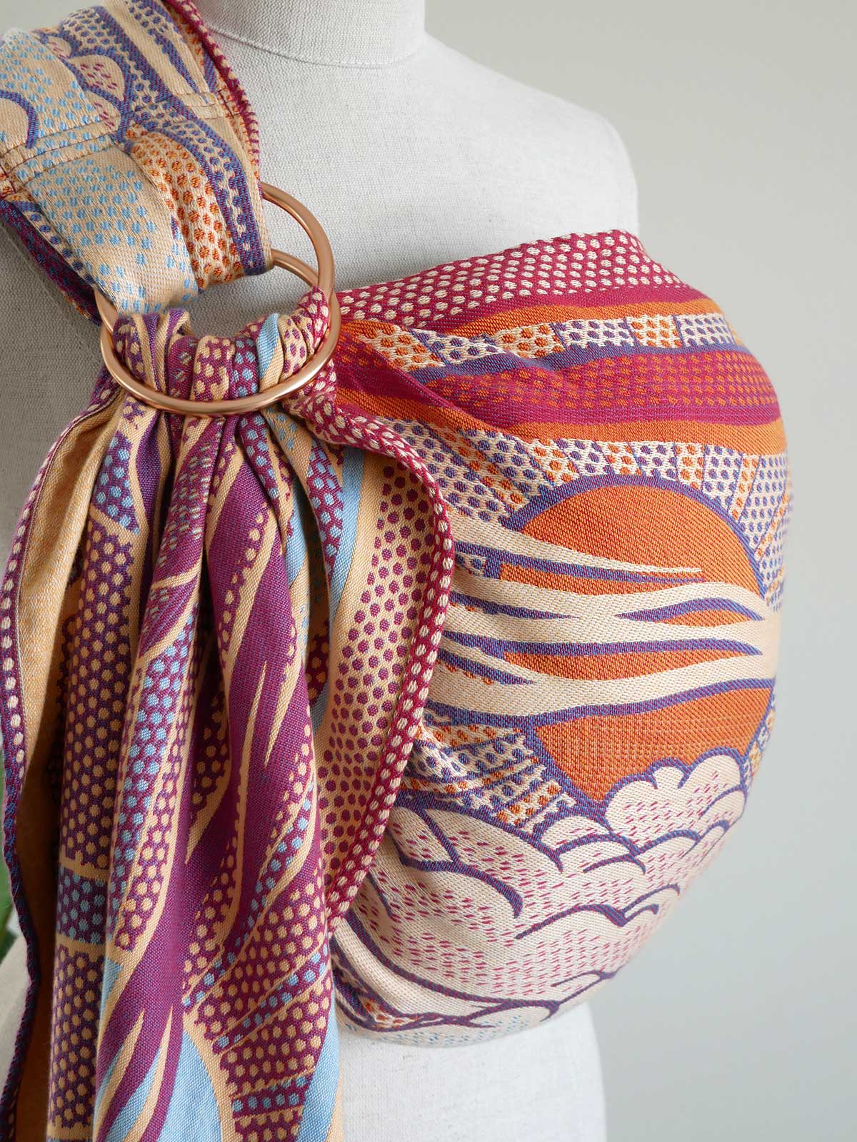 Colorful ring sling on a mannequin with a plain background