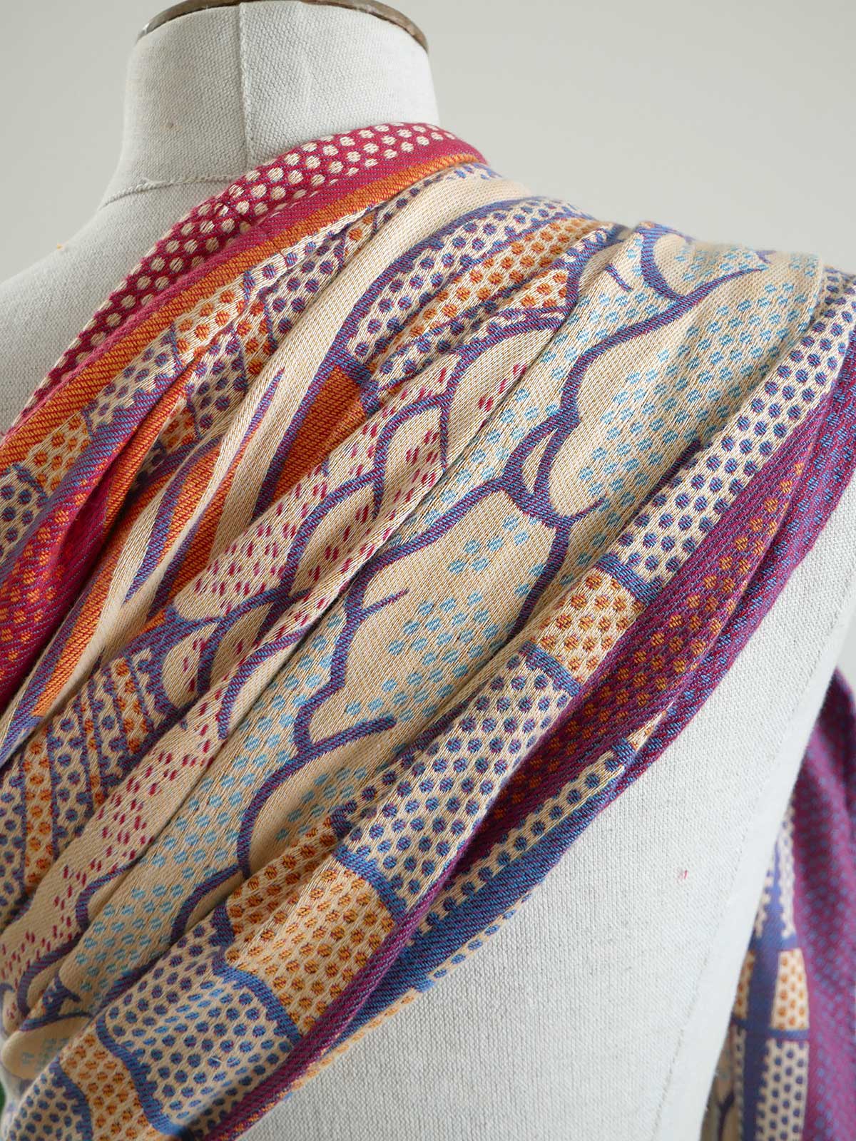 Colorful ring sling on a mannequin against a white background