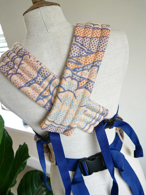 Patterned carrier straps on a mannequin with blue straps.