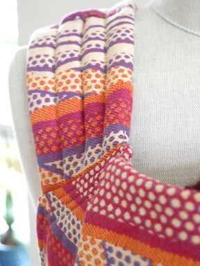 Colorful patterned straps draped over a mannequin