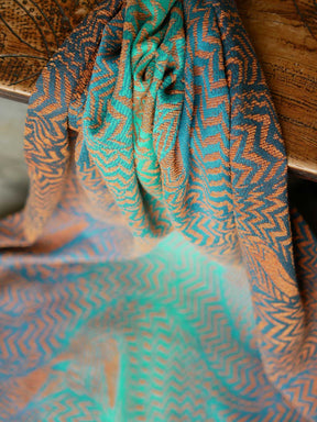 Fabric hanging down with fox pattern Teal and Rust colour baby wrap fabric. 